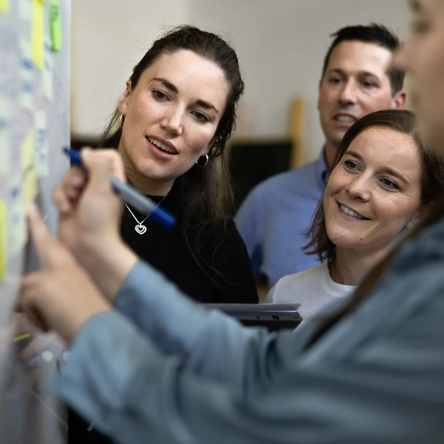 Interaktive Gruppenarbeit mit Post-its an einem Whiteboard im Seminarraum der Universität Liechtenstein.