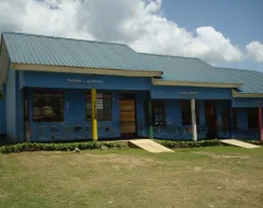 Blaues Schulgebäude mit bemalten Wänden und Säulen.